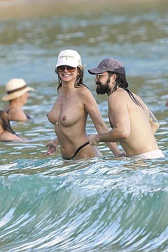 Heidi Klum in bikini and topless on the beach in St. Barths - December 12, 2025