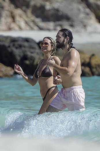 Heidi Klum in bikini and topless on the beach in St. Barths - December 12, 2025
