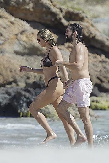 Heidi Klum in bikini and topless on the beach in St. Barths - December 12, 2025