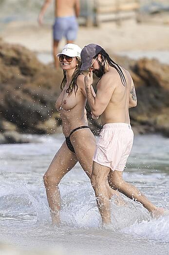 Heidi Klum in bikini and topless on the beach in St. Barths - December 12, 2025