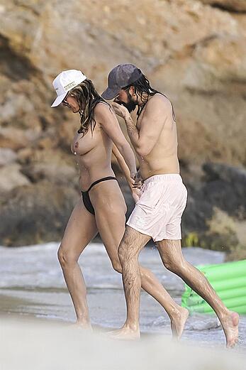 Heidi Klum in bikini and topless on the beach in St. Barths - December 12, 2025