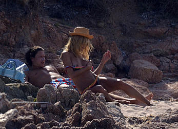 Supermodel Heidi Klum sunbathing topless at a beach in Italy
