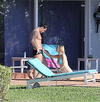 Joanna Krupa enjoying a sunny day in blue bikini at the pool in Miami Beach