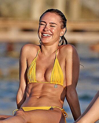 Kimberley Garner in yellow bikini enjoys a sunny beach day in Ibiza - August 18, 2026