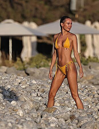 Kimberley Garner in yellow bikini enjoys a sunny beach day in Ibiza - August 18, 2026