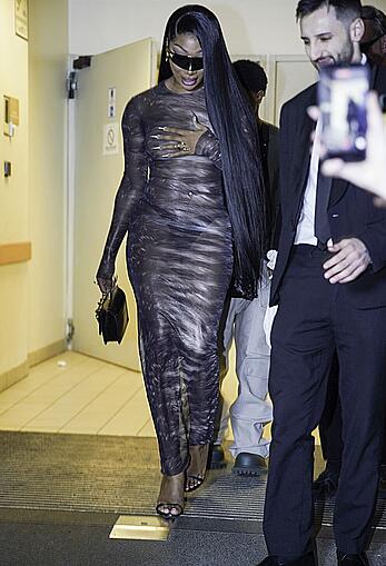 Megan Thee Stallion braless in sheer dress before the runway of Roberto Cavalli show in Milan
