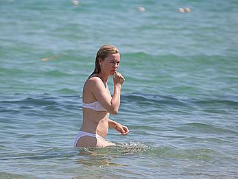 Melissa George pokies in white wet bikinii at a beach in St Tropez