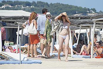 Melissa George pokies in white wet bikinii at a beach in St Tropez