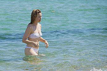 Melissa George pokies in white wet bikinii at a beach in St Tropez