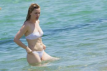 Melissa George pokies in white wet bikinii at a beach in St Tropez