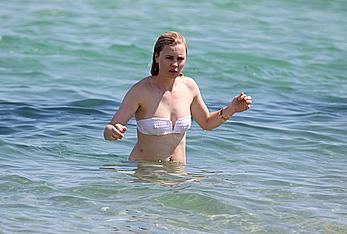 Melissa George pokies in white wet bikinii at a beach in St Tropez