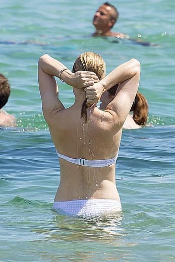 Melissa George pokies in white wet bikinii at a beach in St Tropez