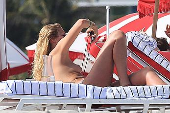 Toni Garrn topless on a beach with friends