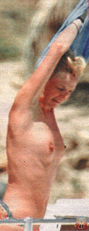 Zoe Ball caught topless on the beach