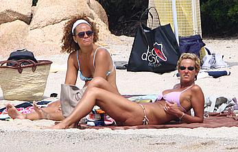 Federica Mancini sunbathing topless on a beach