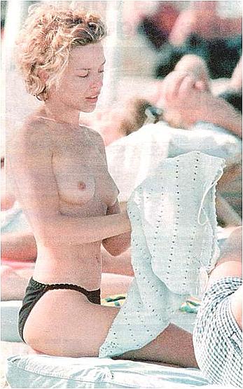 Kylie Minogue caught topless on a beach